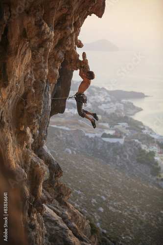 Male rock climber struggling on challenging route, Kalymnos Island, Greece 