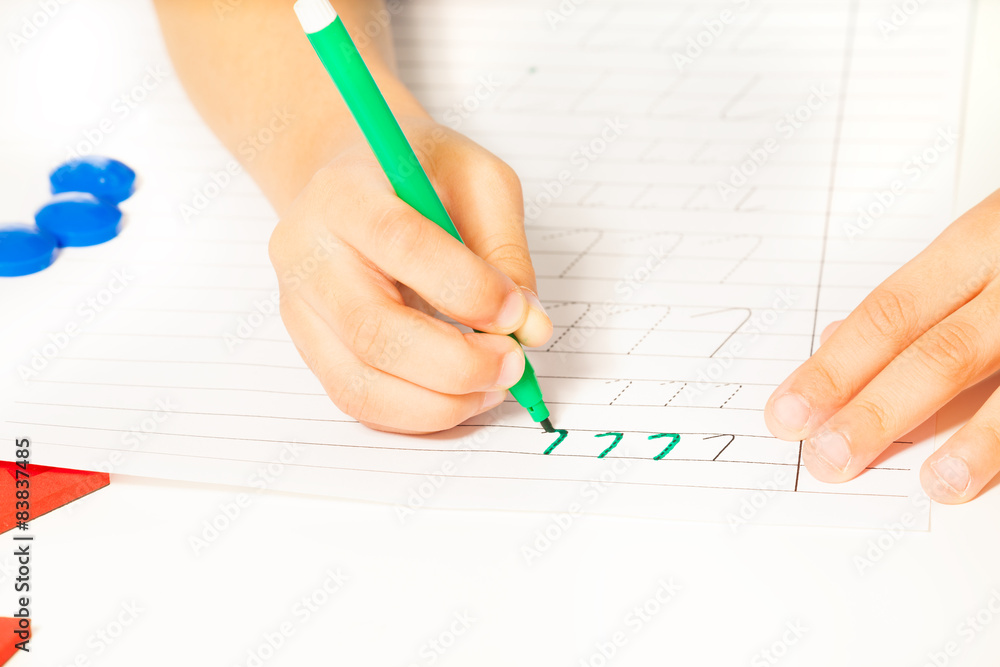 Close-up view of kids hands writing letters Close-up view of kids hands writing letters