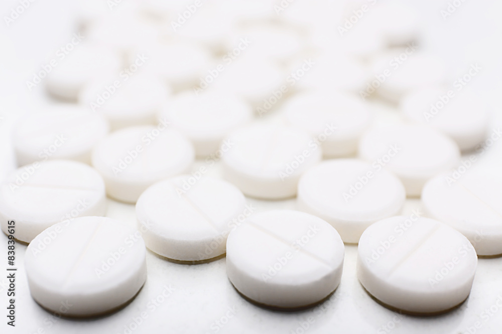 Pile of white pills, closeup Pile of white pills, closeup