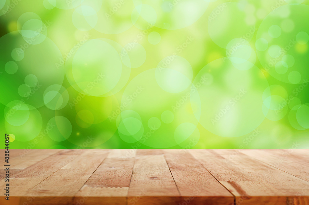 Wood table top on green bokeh abstract background Wood table top on green bokeh abstract background