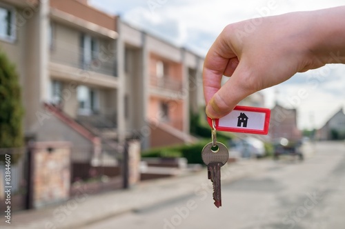 Real estate sells house and holds keys in hand