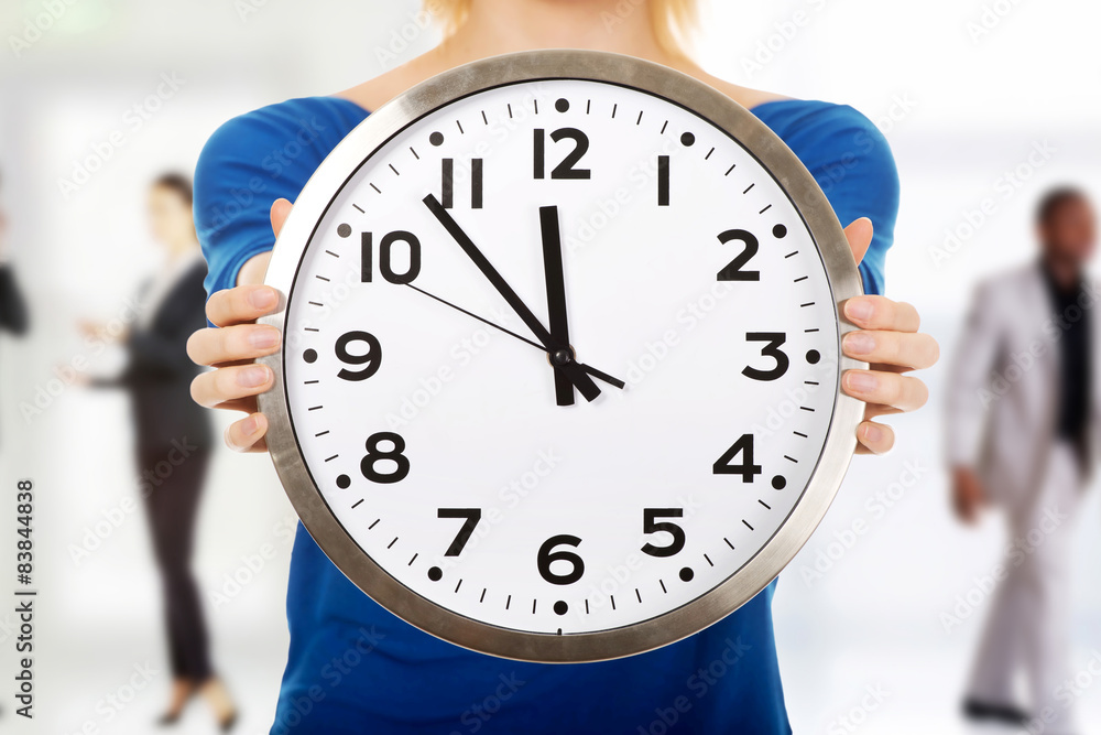 Young woman holding a clock. Young woman holding a clock.