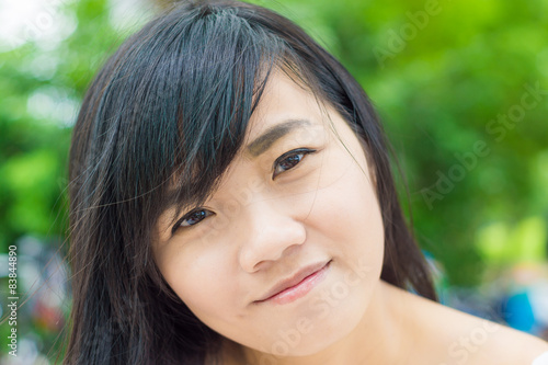 Young woman smiling at camera outdoors