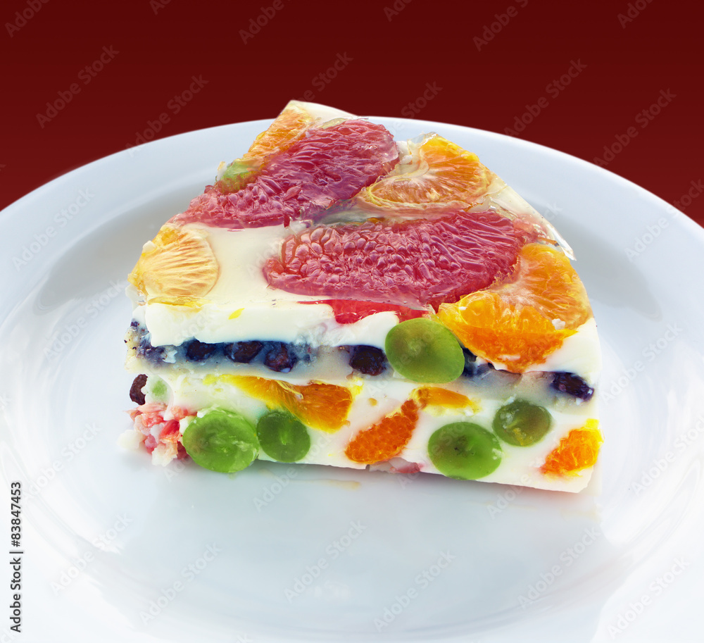 Piece of a colorful jelly cake with fruits Piece of a colorful jelly cake with fruits