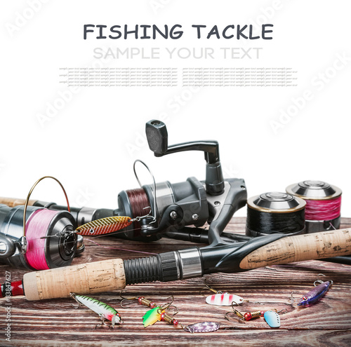 fishing tackle on a wooden table isolated