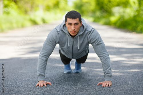 Fitness man exercising push ups, outdoor. Muscular male © nikolas_jkd