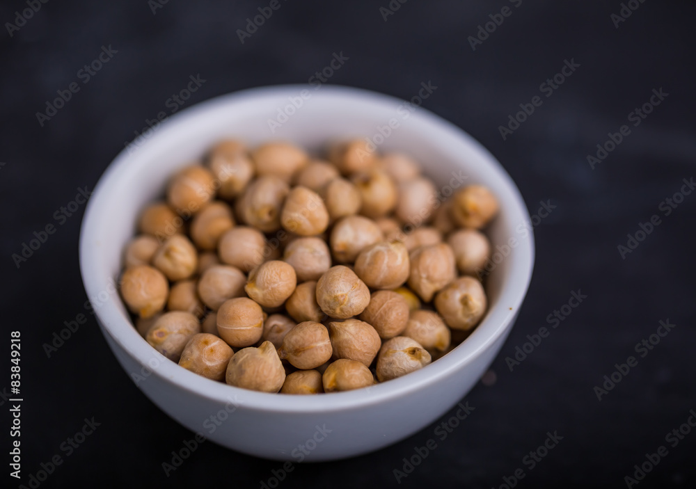 Chickpeas in a white bowl on a black background Chickpeas in a white bowl on a black background
