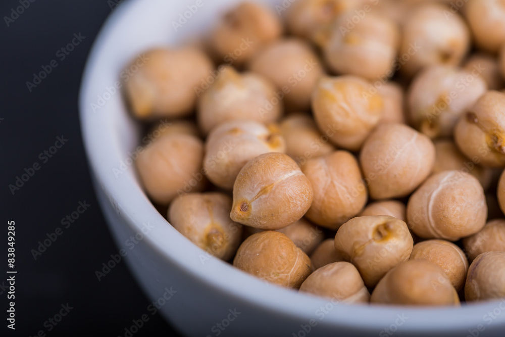 Chickpeas in a white bowl on a black background Chickpeas in a white bowl on a black background
