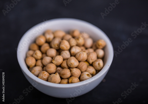 Chickpeas in a white bowl on a black background