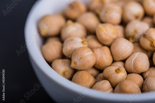 Chickpeas in a white bowl on a black background photo