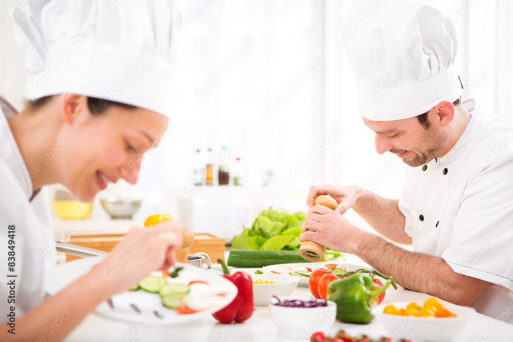Young attractive professional chef cooking in his kitchen Young attractive professional chef cooking in his kitchen