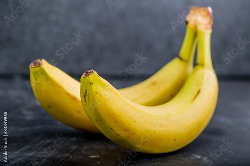 Two bananas on a black background