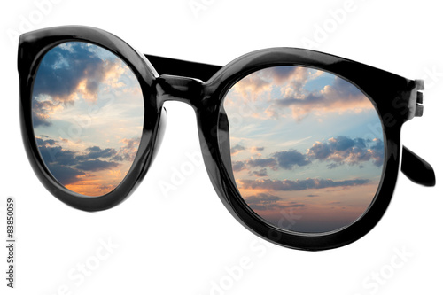 Sunglasses have a sunrise sky reflecting on isolated backgroun