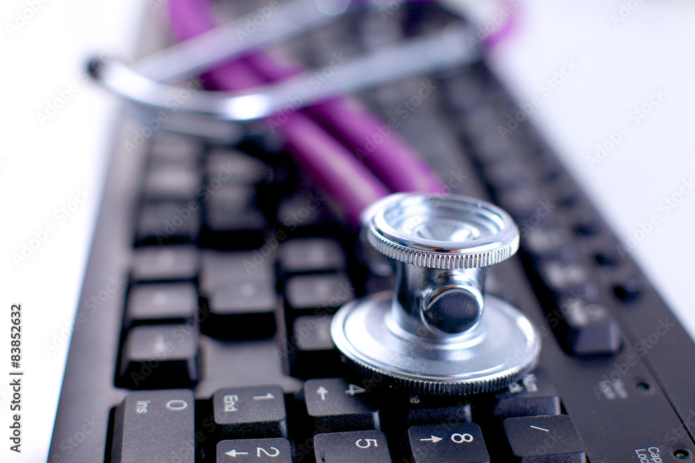 Violet stethoscope on a laptop computer Violet stethoscope on a laptop computer