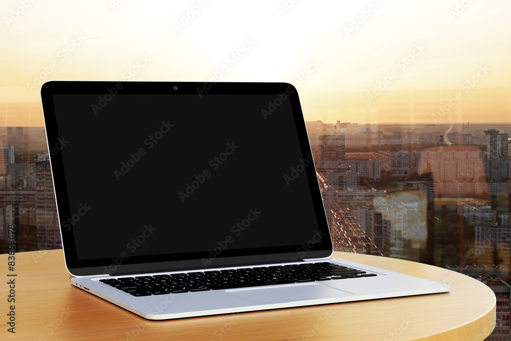 blank laptop on a table by the window blank laptop on a table by the window