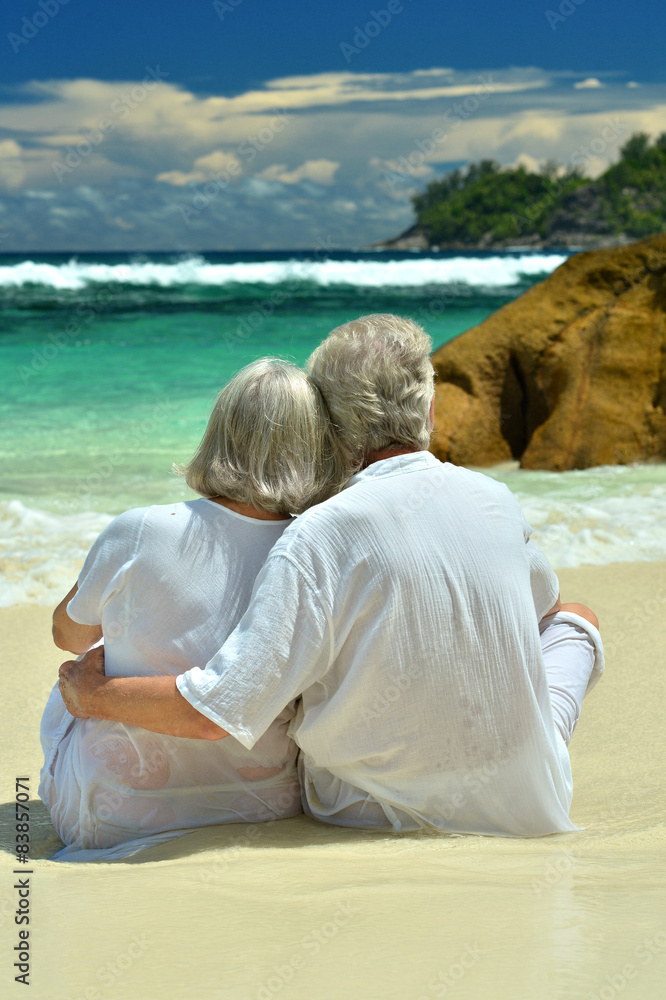 Elderly couple sitting on the shore Elderly couple sitting on the shore
