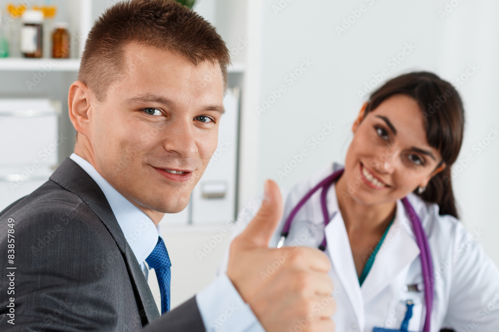 Businessman showing thumb up with doctor Businessman showing thumb up with doctor