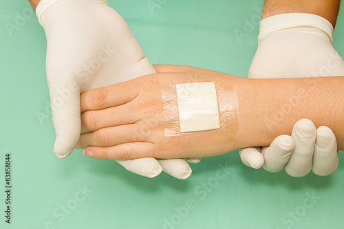 doctor applying plaster on pateint's hand