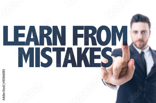 Business man pointing the text: Learn From Mistakes
