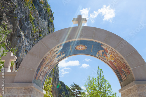 arch decorated with mosaics - entrance to the monastery Ostrog photo