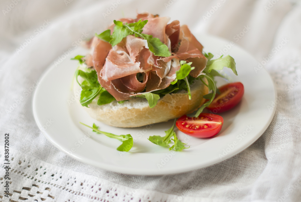brioche with prosciutto, arugula and cherry tomatoes brioche with prosciutto, arugula and cherry tomatoes