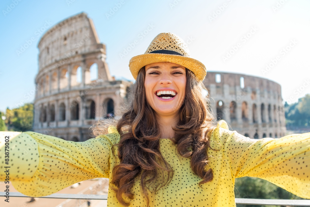 Smiling woman tourist taking selfie at Rome Colosseum