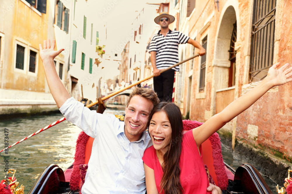 Tourists on travel happy couple in Venice gondola