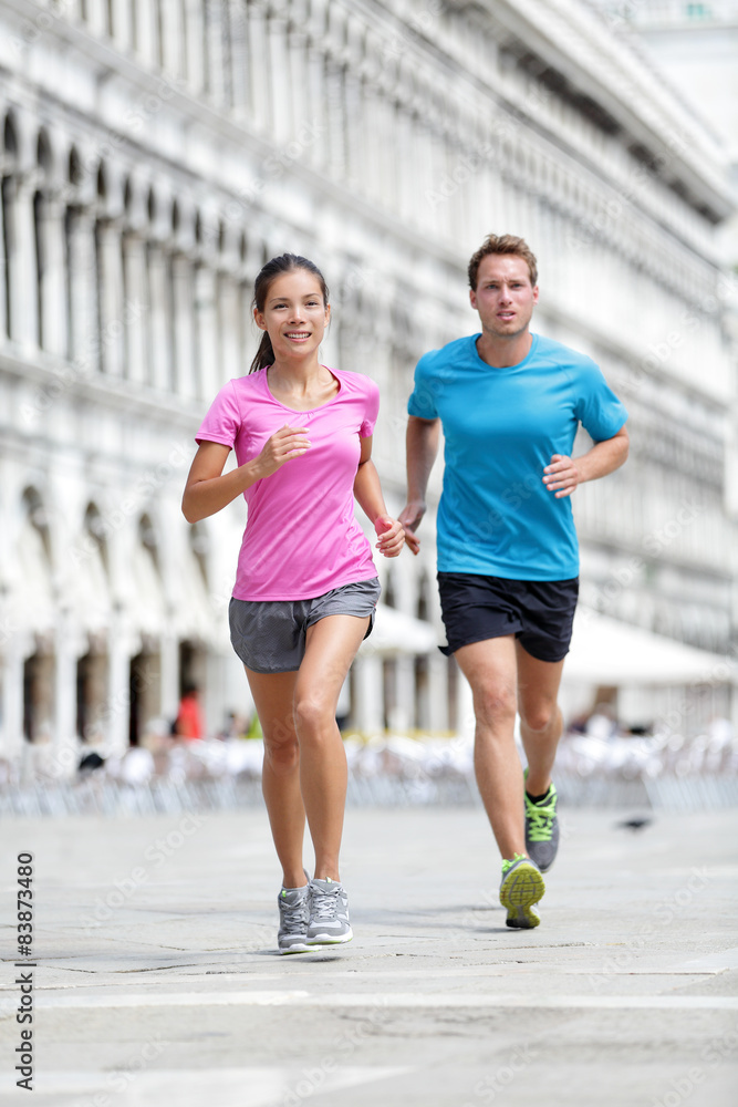Running runner couple jogging in Venice