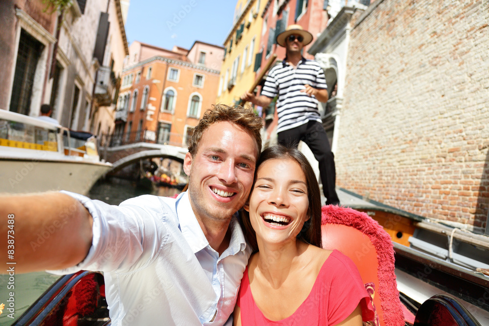 Selfie couple taking picture in Venice gondola