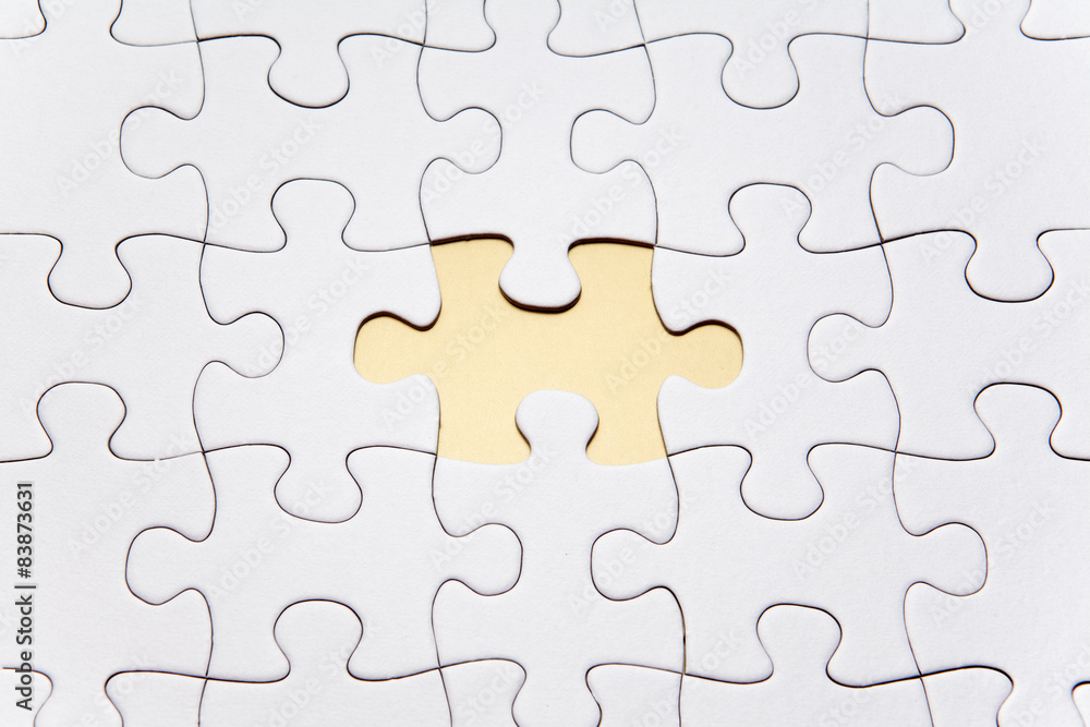 White puzzle shown with one piece missing White puzzle shown with one piece missing