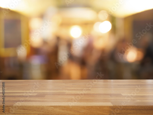 Empty wooden table and blurred cafe background