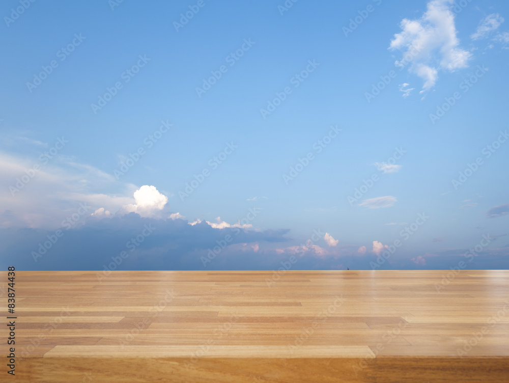 Empty wooden table with blue sky and cloud