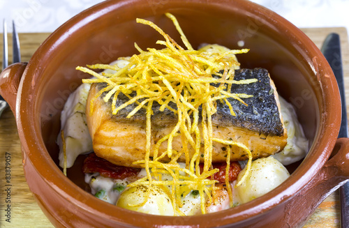 Baked salmon fillet with vegetables in a restaurant