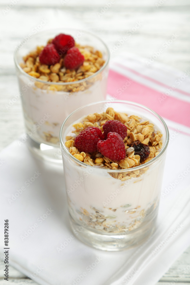 Muesli with yogurt and raspberries in a glass Muesli with yogurt and raspberries in a glass