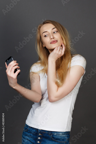 young pretty blonde women taking selfie on cell phone