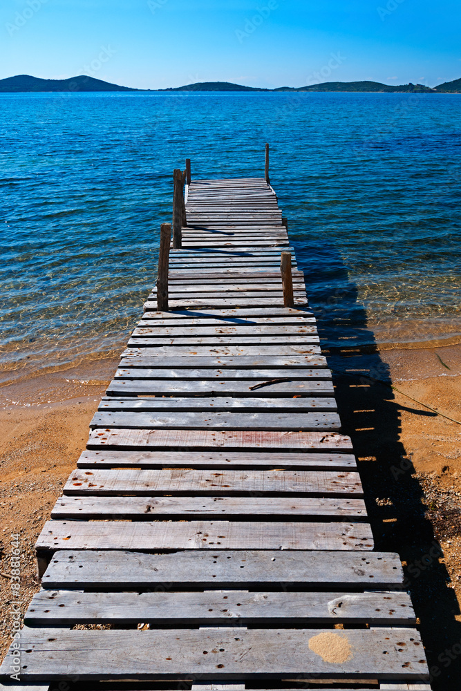 Wooden pier jutting out to sea Wooden pier jutting out to sea