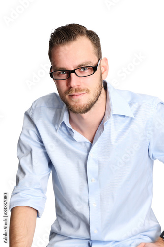 Man sitting down wearing glasses and a blue shirt