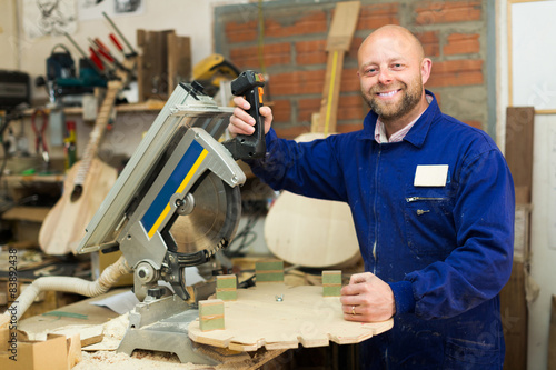 Woodworker on lathe in workroom