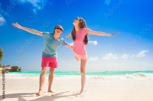 happy young couple on the beach smiling having fun