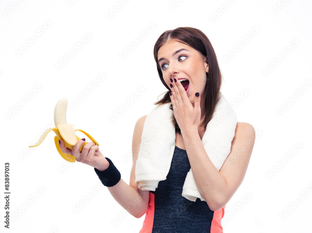 Funny sports woman looking on banana Funny sports woman looking on banana