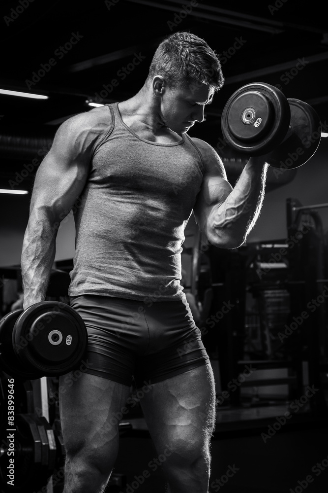 Muscular man with dumbbells Muscular man with dumbbells