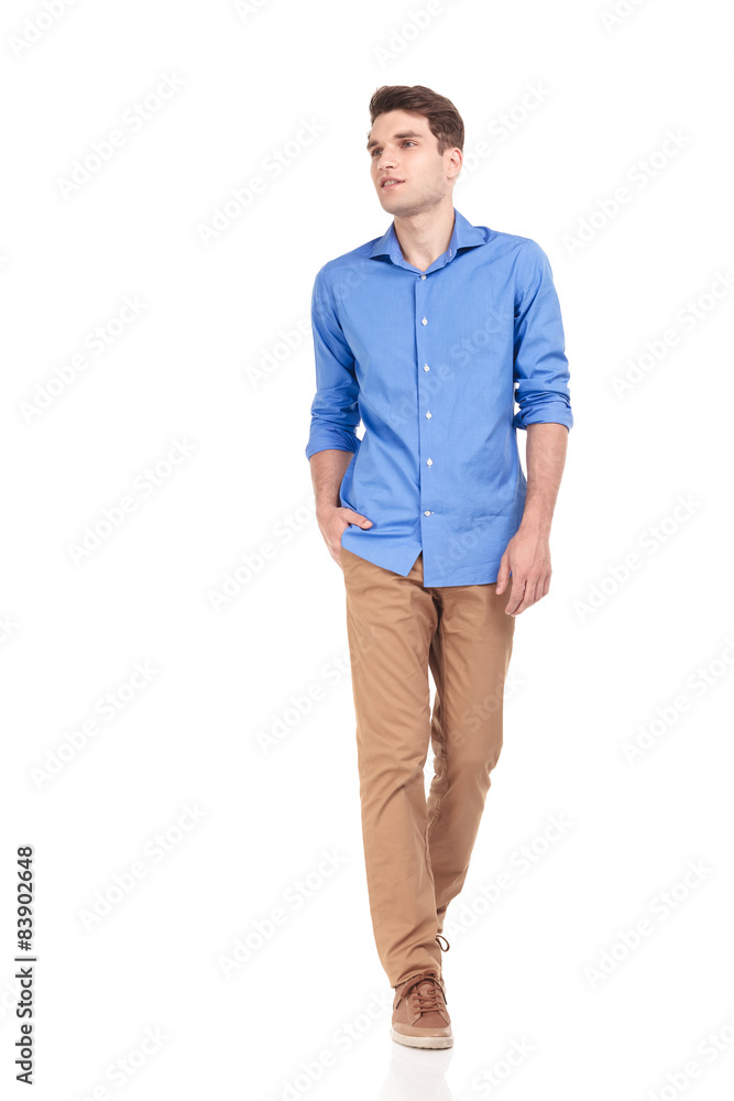 Fototapeta premium casual man walking with his hand in pocket on