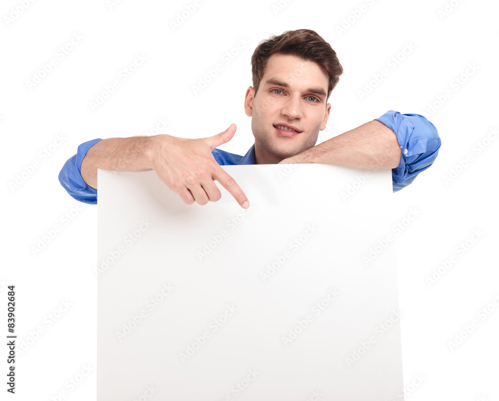 handsome man pointing his finger to a white board. handsome man pointing his finger to a white board.