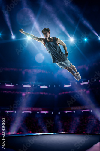 Young man is jumping on trampoline © 103tnn