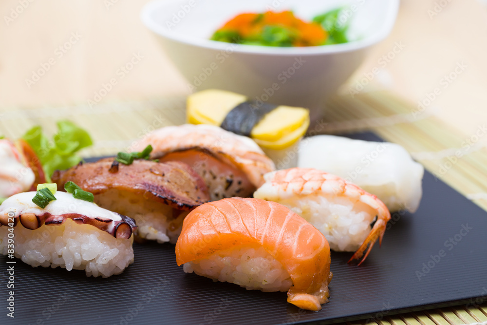 Sushi assortment on black dish, close up Sushi assortment on black dish, close up