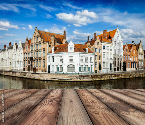 Wooden planks with Bruges canals in background