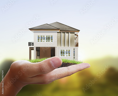 Businessman holding house model