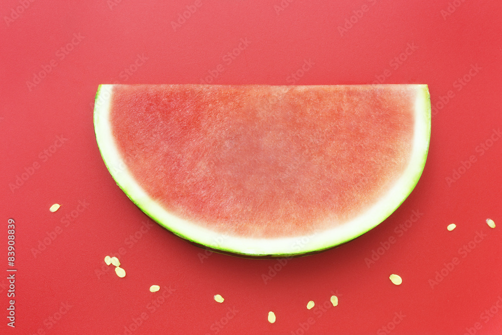 Slice of watermelon without seeds on red background Slice of watermelon without seeds on red background