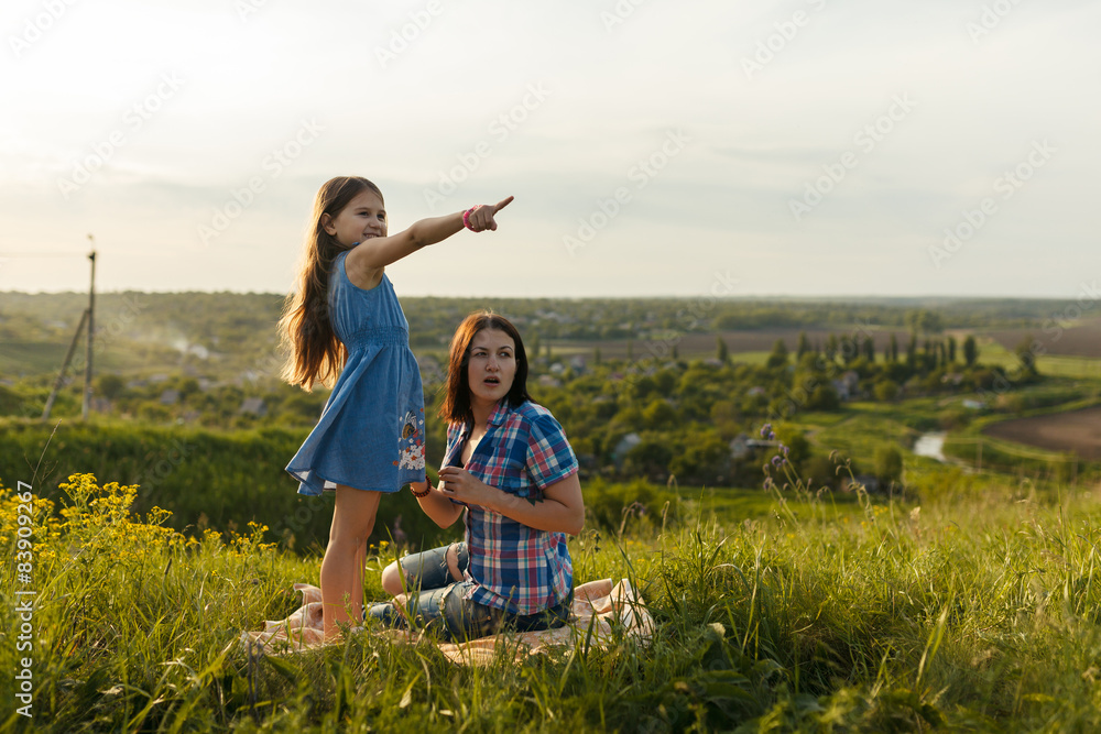 daughter points a finger at something interesting