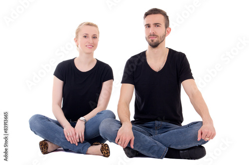 young man and woman sitting on the floor isolated on white